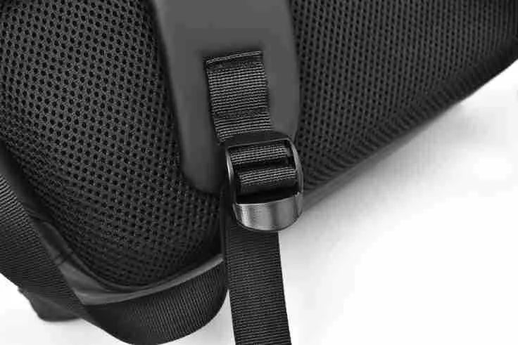 Men's large capacity waterproof backpack in black colour showing PU leather construction and computer bag accommodation