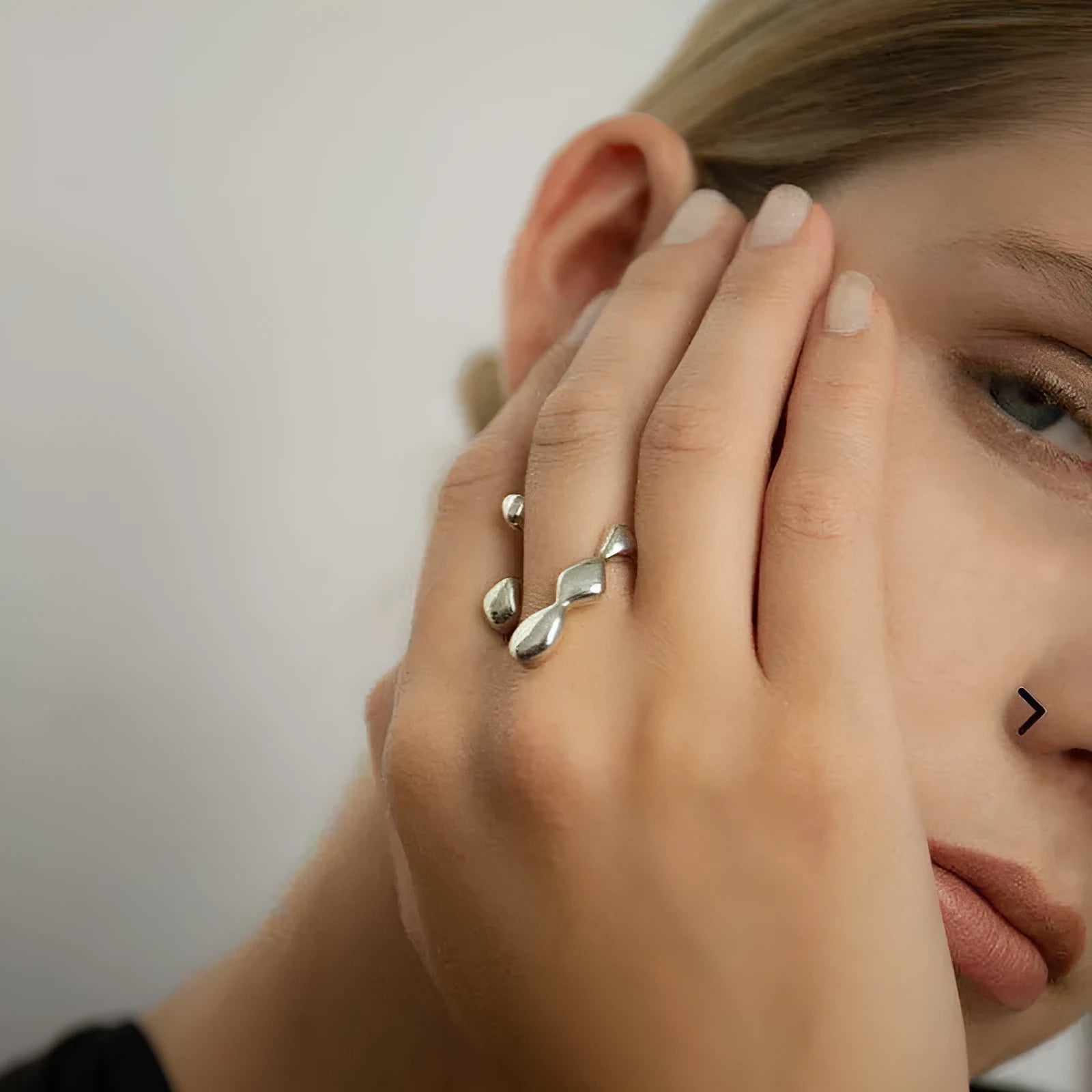 Gold and silver brass opening ring with sphere circle design on a woman's hand.