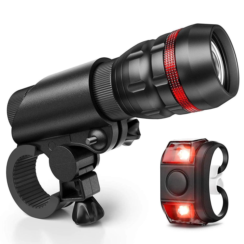 Bicycle headlight and taillight set with metal mounting bracket on a black background.