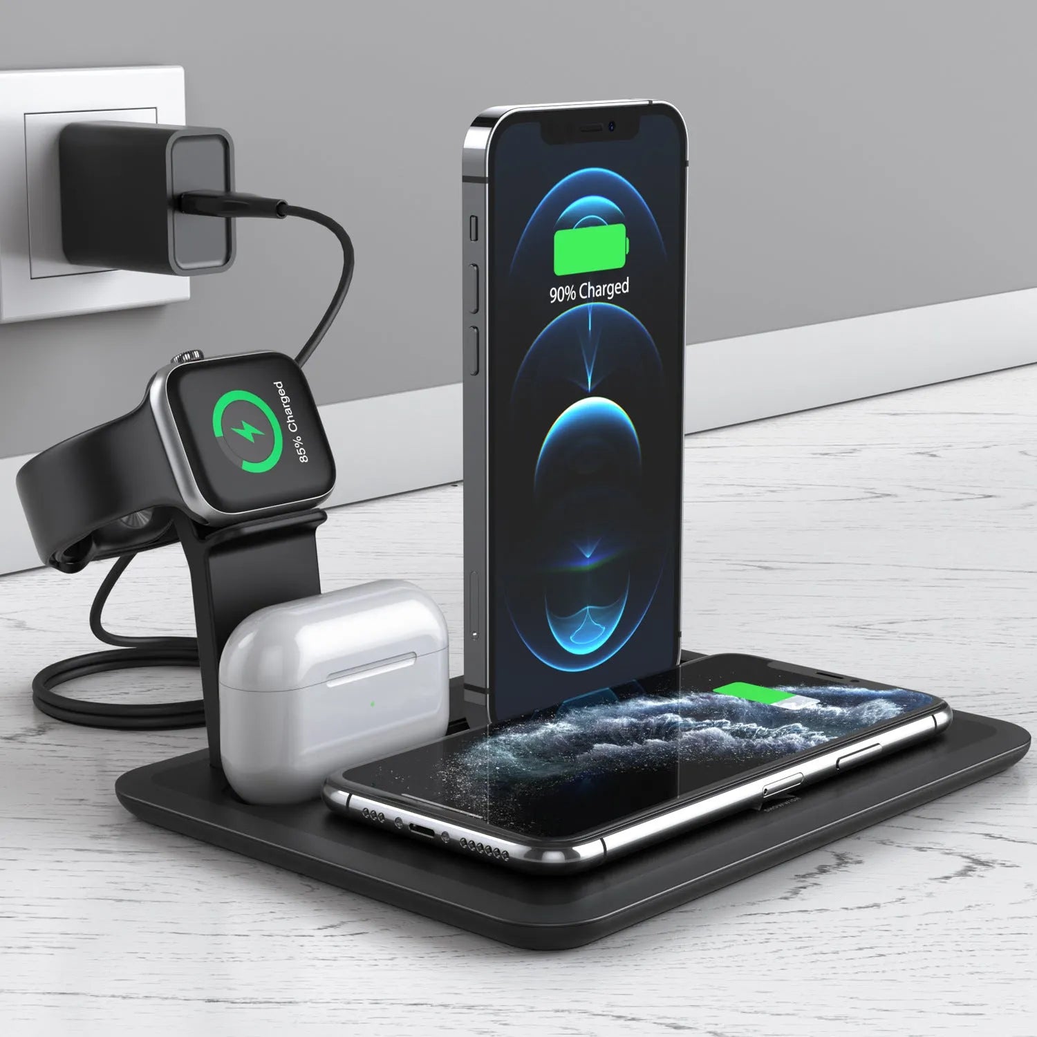 Black and white wireless charging station for mobile phone, smartwatch, and headphones on a desk.
