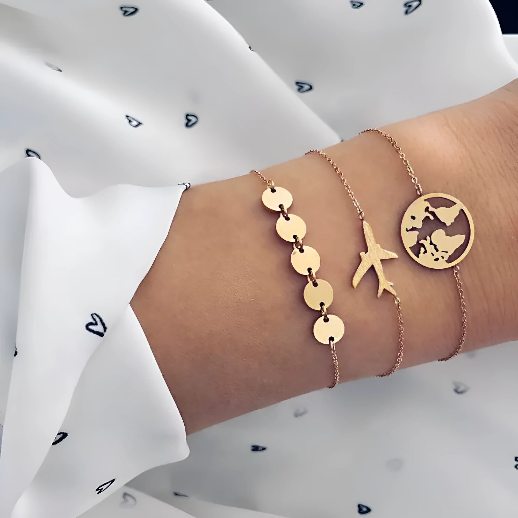 Set of three women's bohemian bracelets with heart-shaped aircraft map charms in alloy metal.