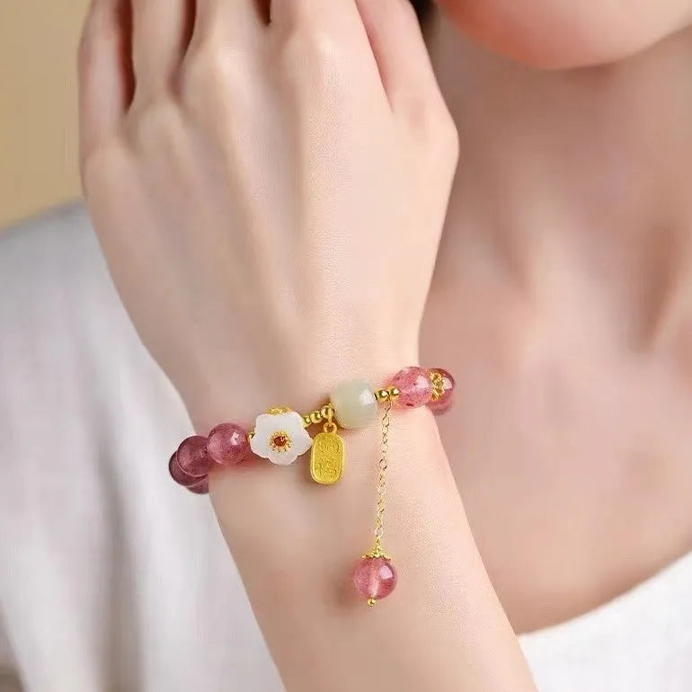 Handmade strawberry quartz crystal bracelet with a choice of moon, XINGX, or pearl charm on a natural crystal band.