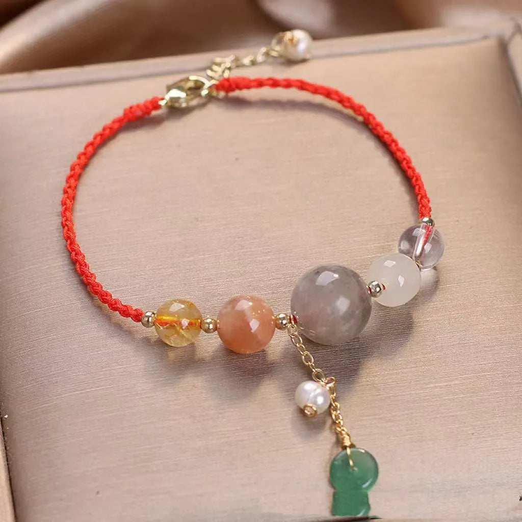 Hand-woven women's bracelet with peace buckle, crystal beads, and sequins in red, green, or blue.