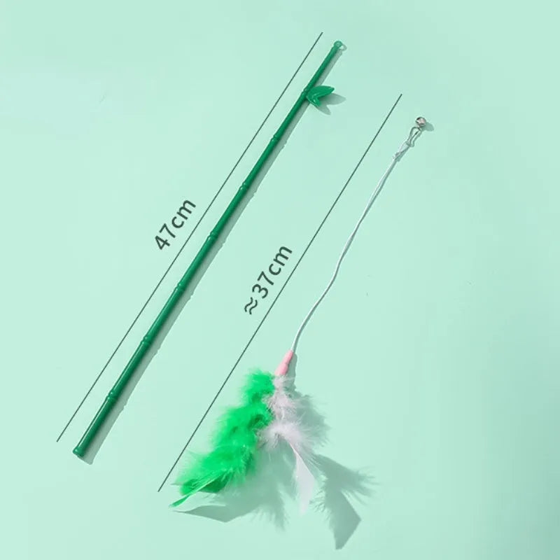 Green interactive cat feather wand toy with bells attached for indoor play and training