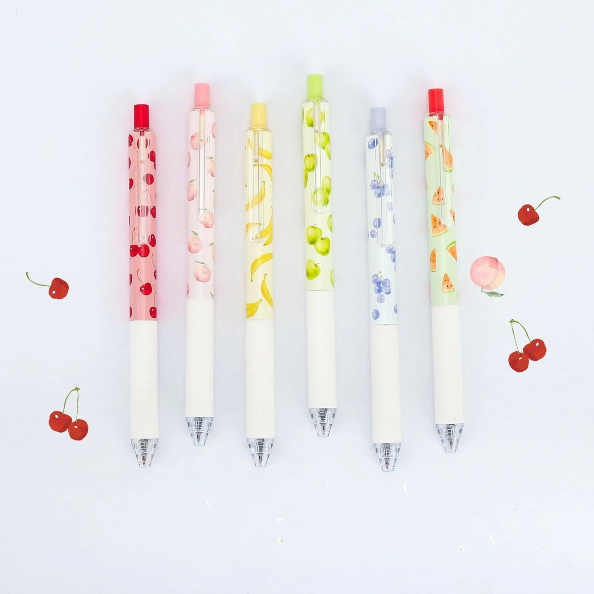 Three fruit-scented pressurised pens with push-button mechanisms and 0.5mm black refills