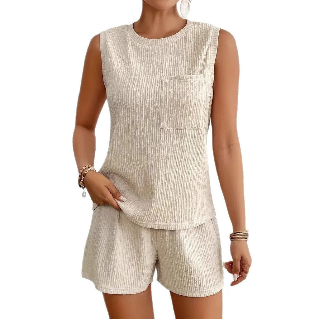 Solid colour apricot polyester sleeveless vest and matching shorts co-ord set laid flat.