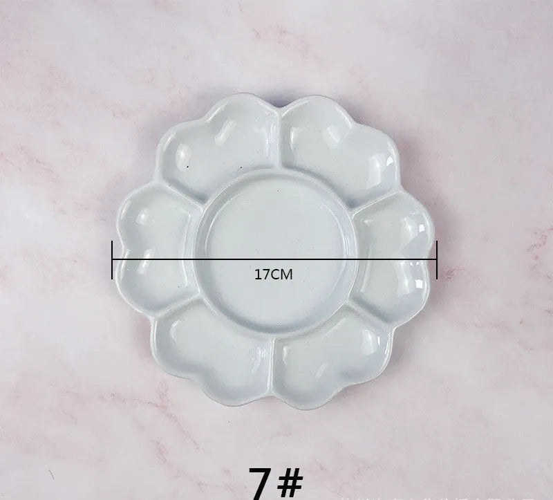 White handmade ceramic plum blossom shaped artist palette for painting.