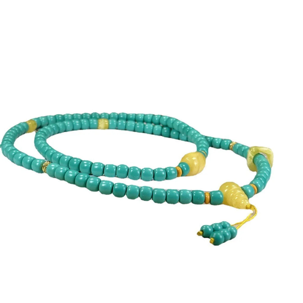 Turquoise mesh flower lucky pendant necklace with adjustable ball bead chain on display