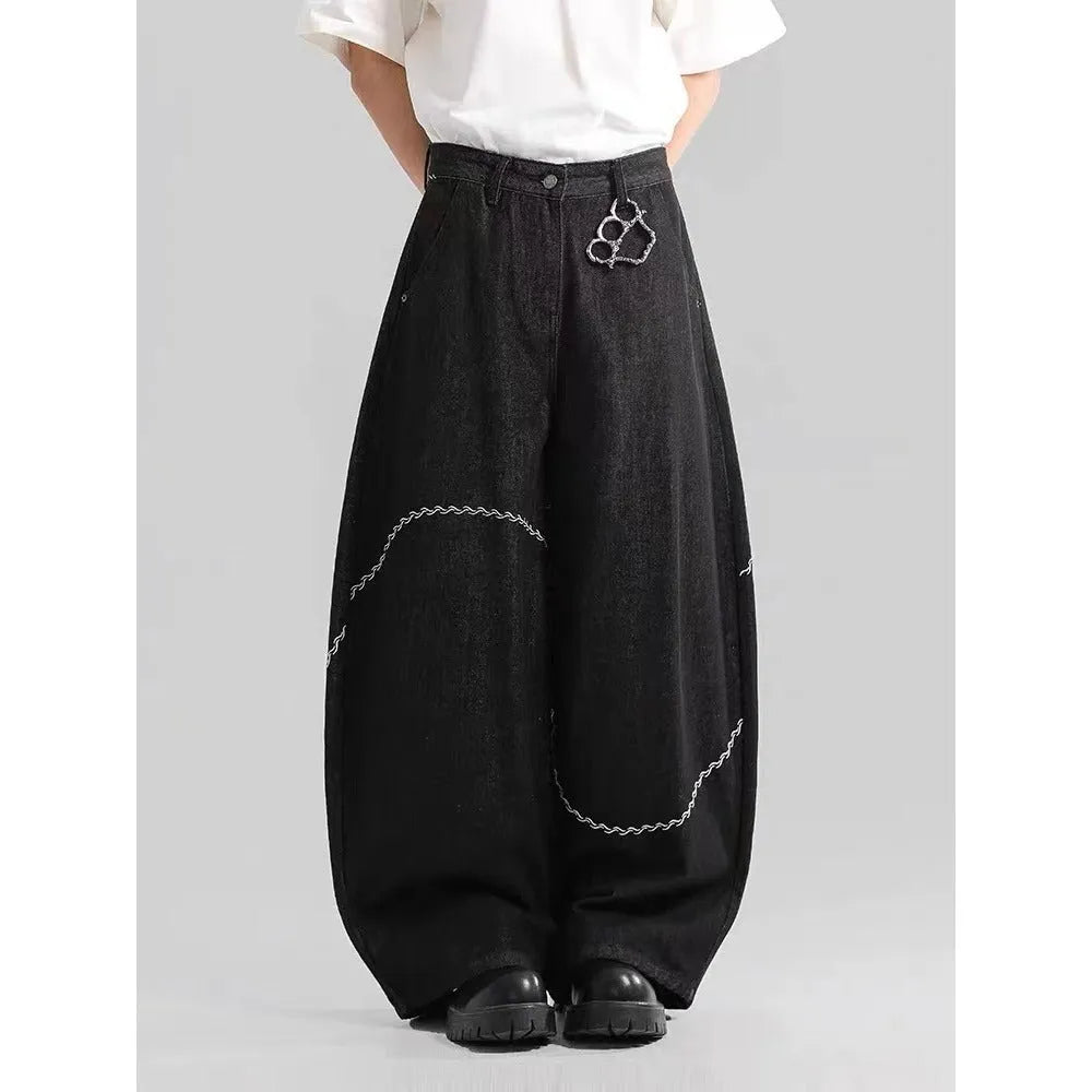 Black straight-leg men's trousers with a mid-waist and zip fly on a hanger.