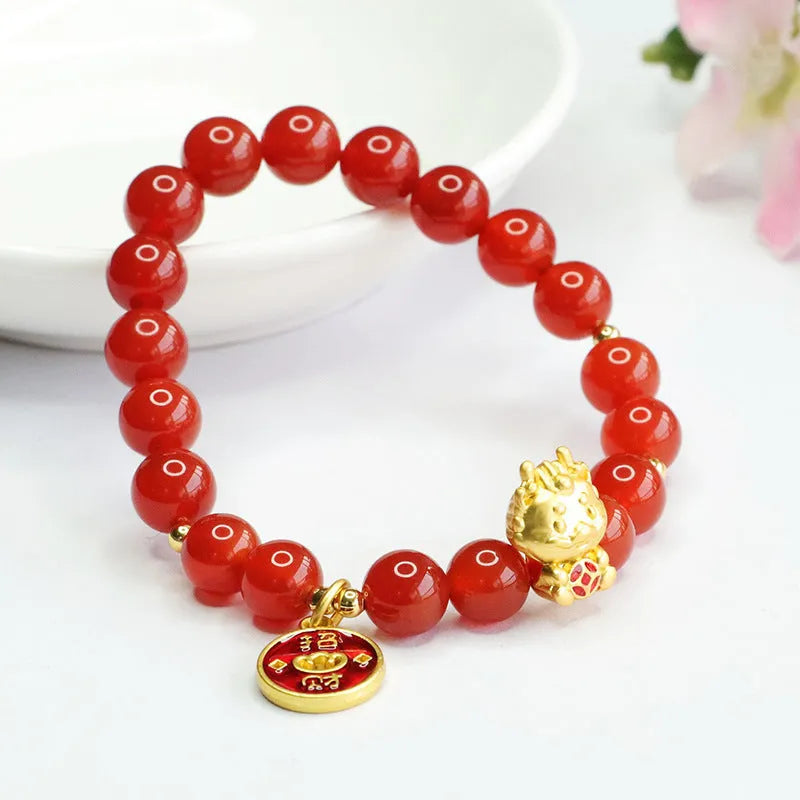 Close-up of a Chinese zodiac dragon bracelet with 8mm red agate beads on a wrist.