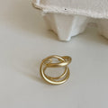 Geometric open ring for women with 3D interlaced matte metal design in gold and silver colour options.