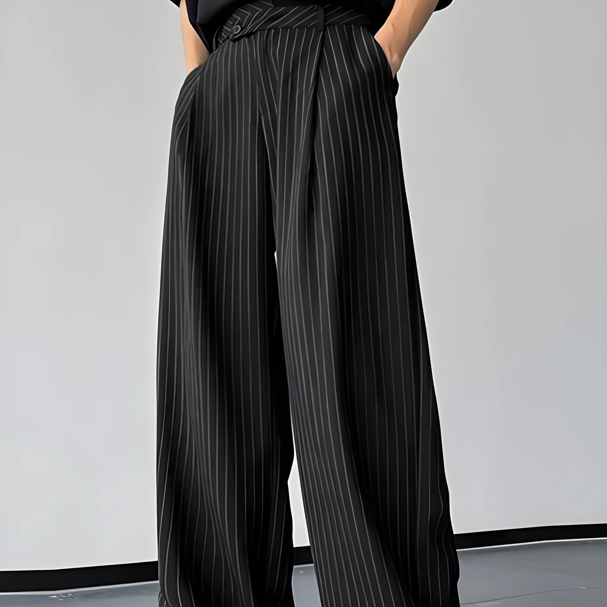 Black men's trousers with vertical stripes and pleated design featuring elastic waistband