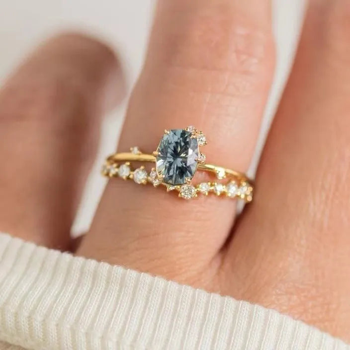 Gold plated women's ring with green zircon stones in floral design, shown as a pair for couple wear