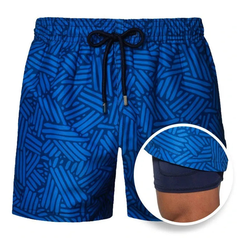 Men's printed double-layer beach shorts in striped cotton blend with elastic waist on a sandy beach