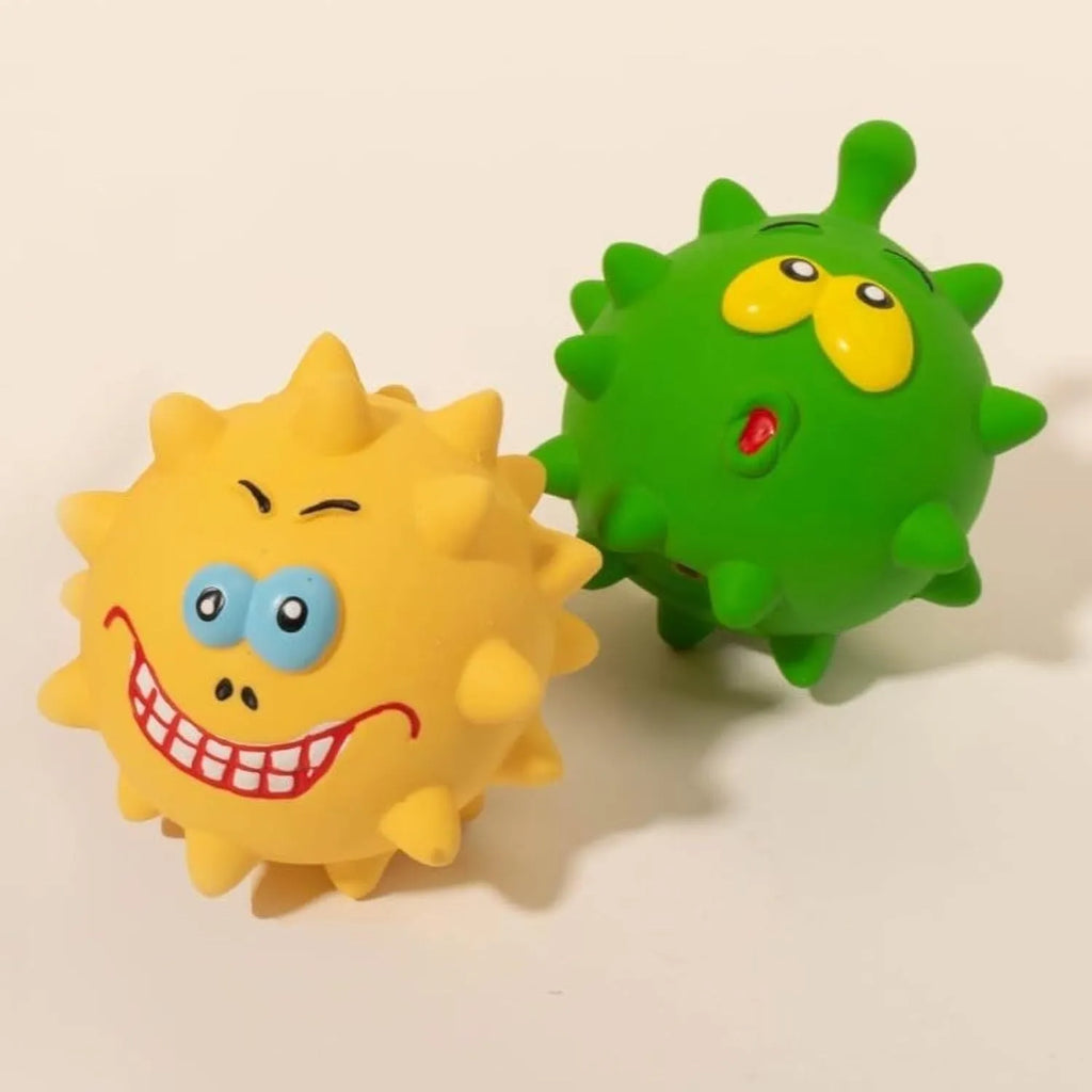 Set of four coloured latex squeaky dog balls with cute face designs on blue green red yellow backgrounds
