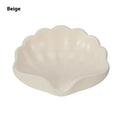 White and pink plastic shell-shaped soap dish for bathroom counter.