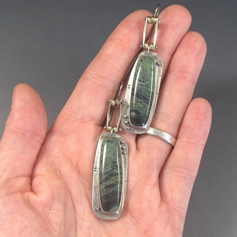 Two-tone marble pattern geometric drop earrings with alloy construction, front and side views
