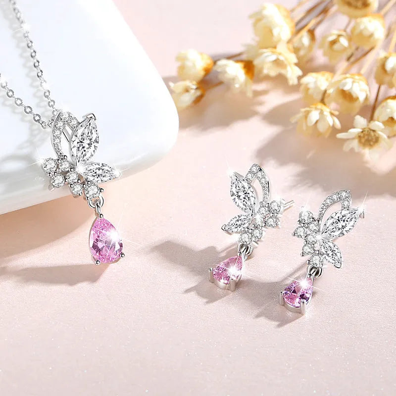 A pair of silver stud earrings with a faceted crystal butterfly design on a post backing.
