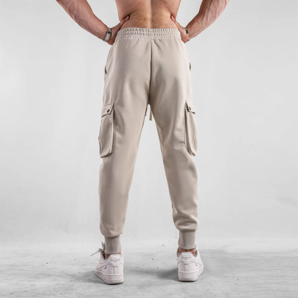 Men's loose-fit ankle-tied cotton sports trousers in solid colour with multi-pocket design