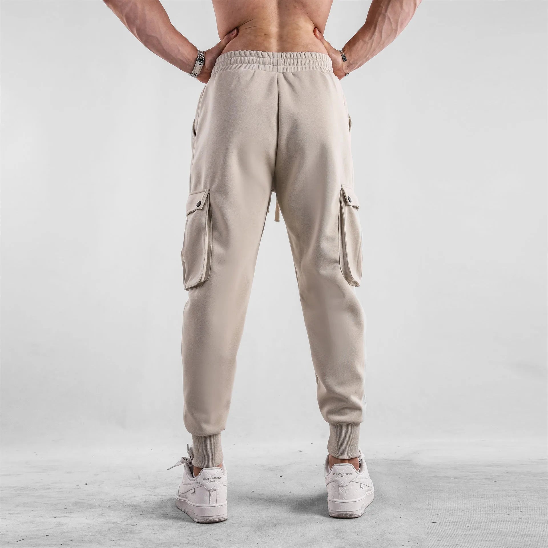 Men's loose-fit ankle-tied cotton sports trousers in solid colour with multi-pocket design