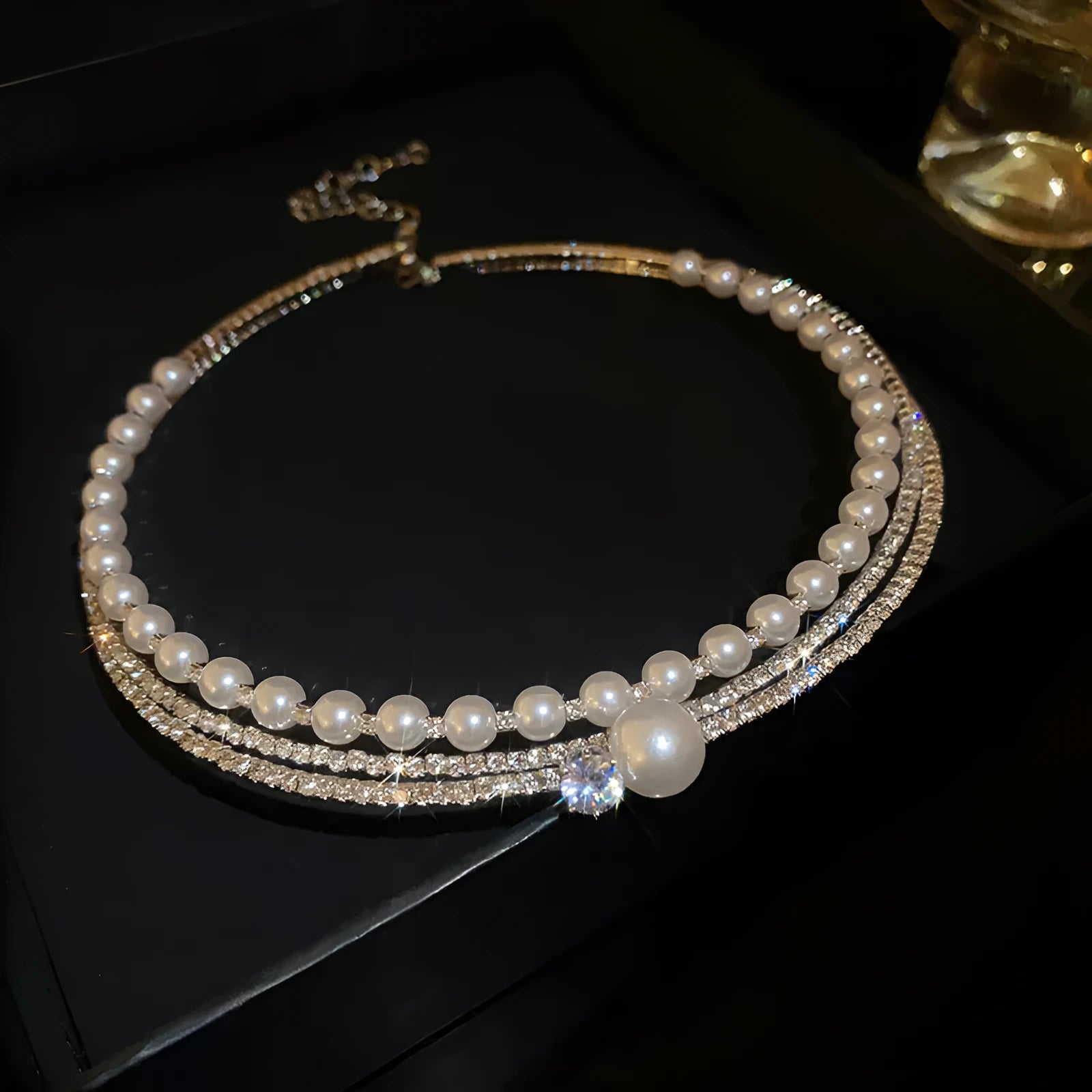 Silver geometric round curved necklace positioned on collar bone with adjustable chain
