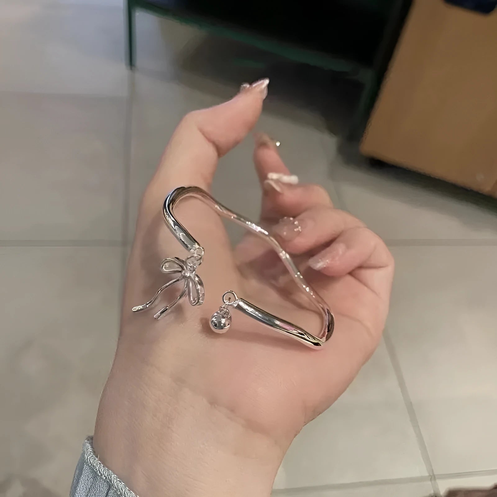 Silver adjustable bow bell opening bracelet made from zinc alloy