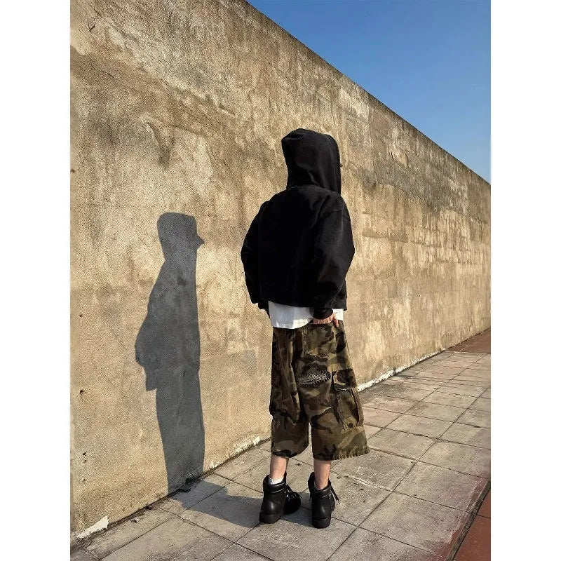 Men's loose camouflage cropped jeans with ripped knees and retro patch detailing on a thin cotton fabric.