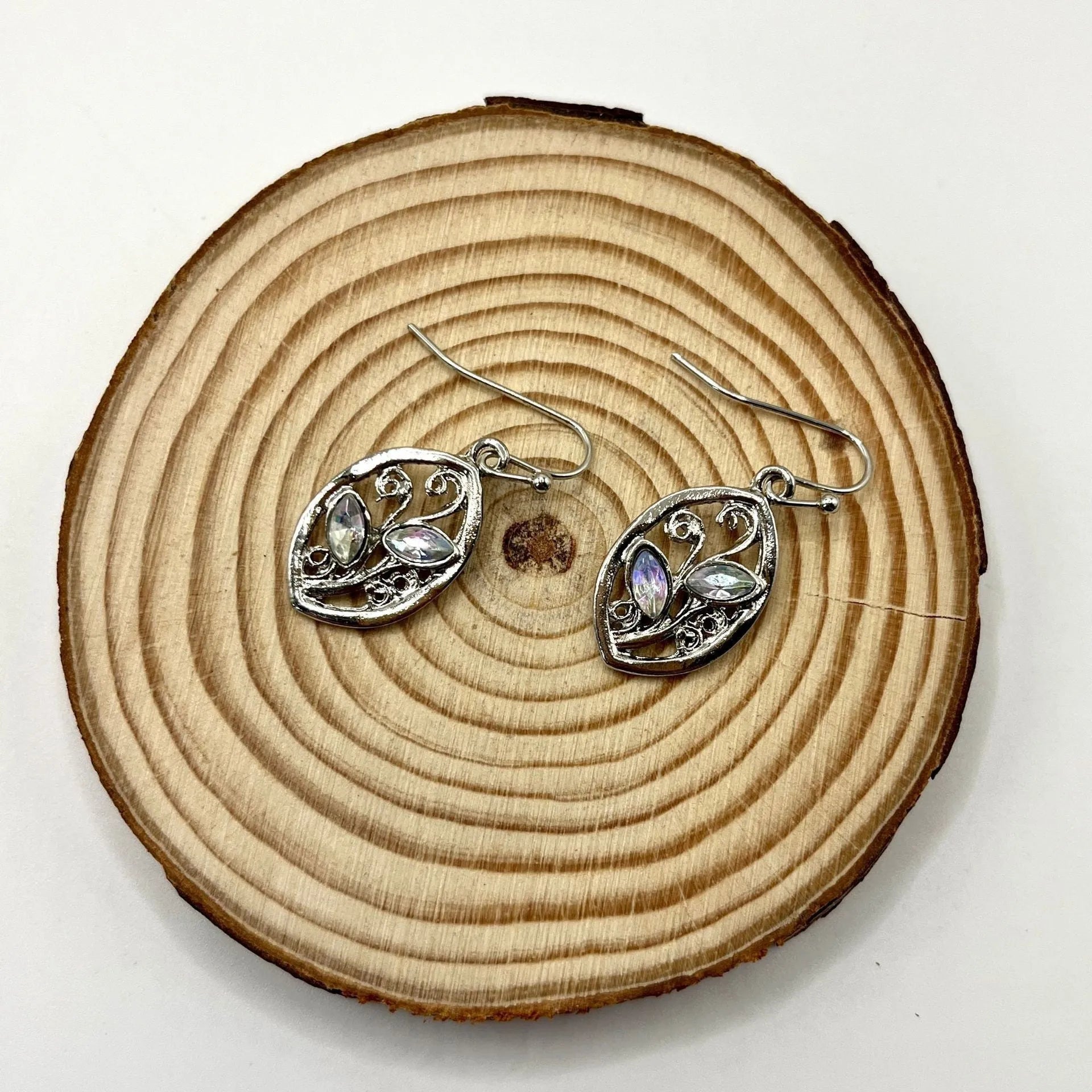 Silver colour leaf-shaped alloy earrings with embedded colourful moonstone centrepieces