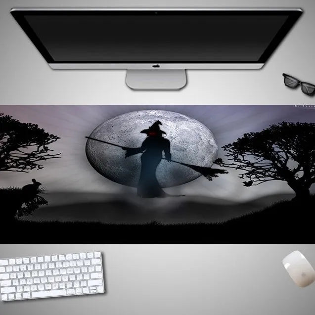 Oversized Halloween-themed computer mouse pad with non-slip rubber cloth backing on wooden desk