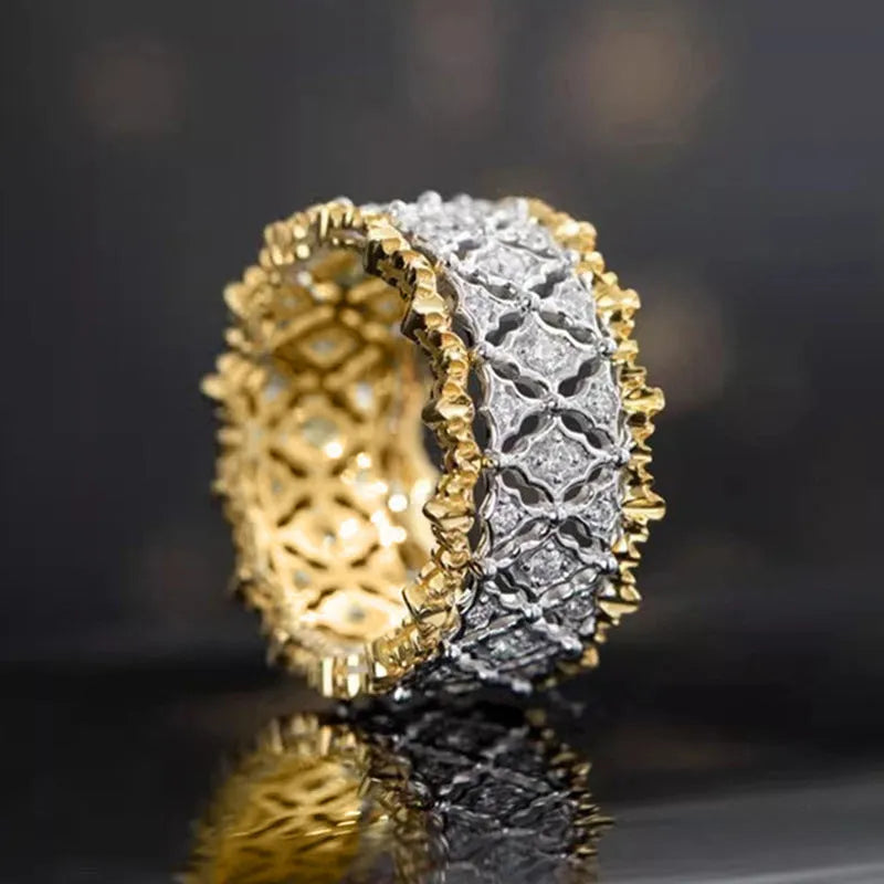 Geometric two-tone copper ring with a round zircon stone on a finger.