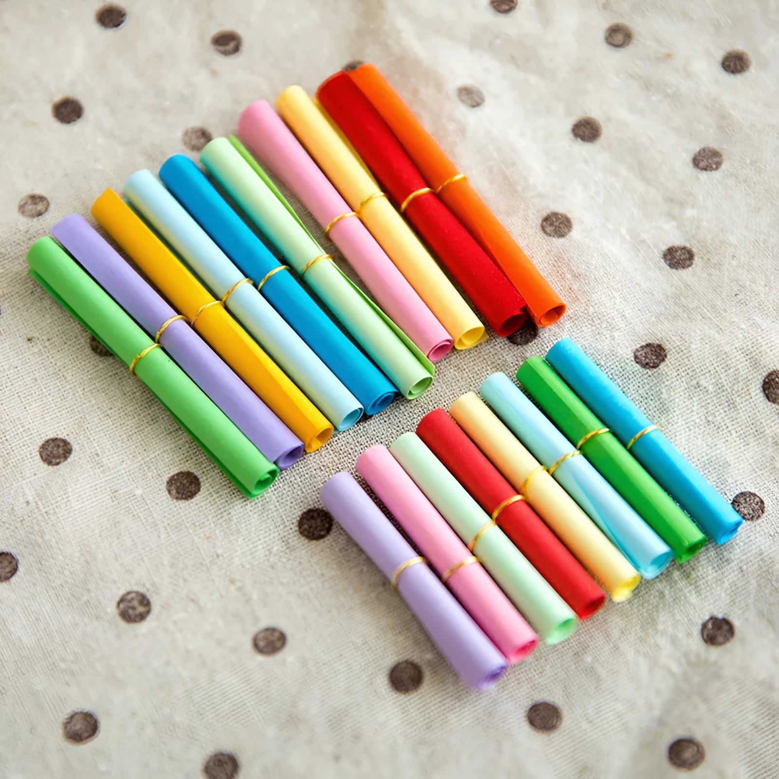 Assorted coloured mini paper scrolls with eyelets in 3x7cm and 7x7cm sizes for drift bottles