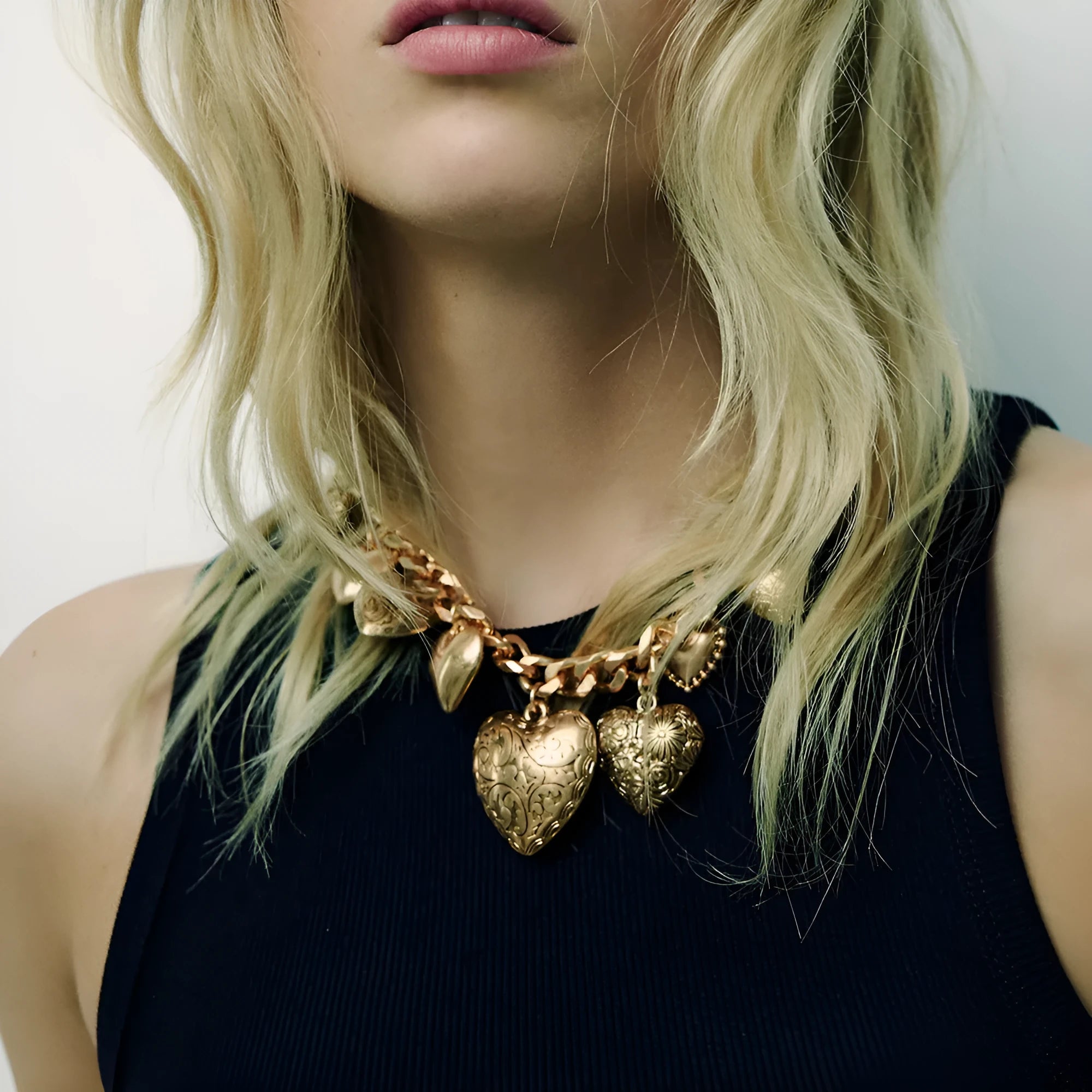 Gold carved heart pendant necklace on adjustable metal chain for women