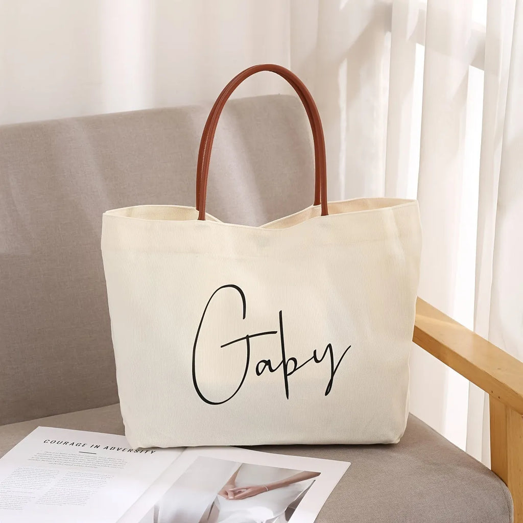 Large beige white canvas tote bag with a reinforced flat base and roomy interior.
