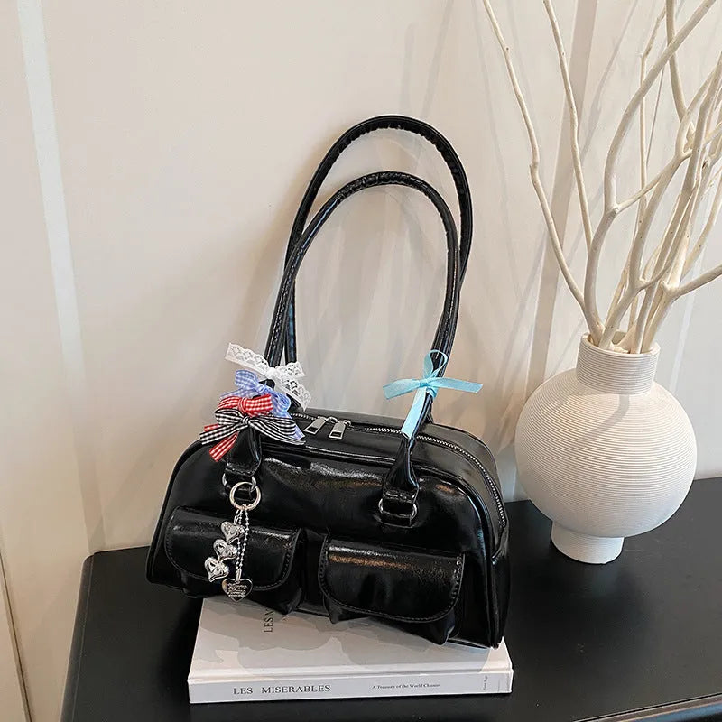 Retro pillow-shaped PU leather women's handbag with double shoulder strap in black colour with ribbon pendant