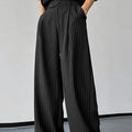 Black men's trousers with vertical stripes and pleated design featuring elastic waistband