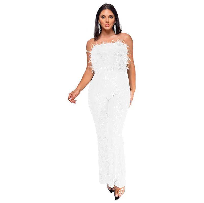 Women's black sleeveless backless jumpsuit with flared legs and sequin detailing.