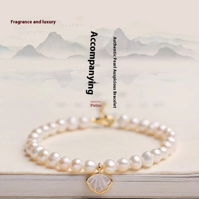 Women's freshwater pearl bracelet with fan-shaped design showing elastic and chain fastening options
