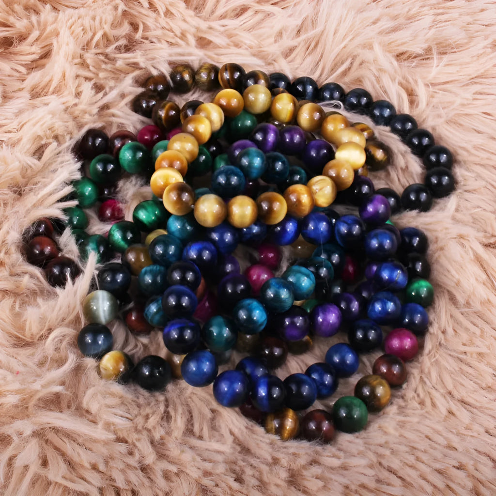 Finished round tiger eye crystal bracelet in multiple colour options on a wrist.