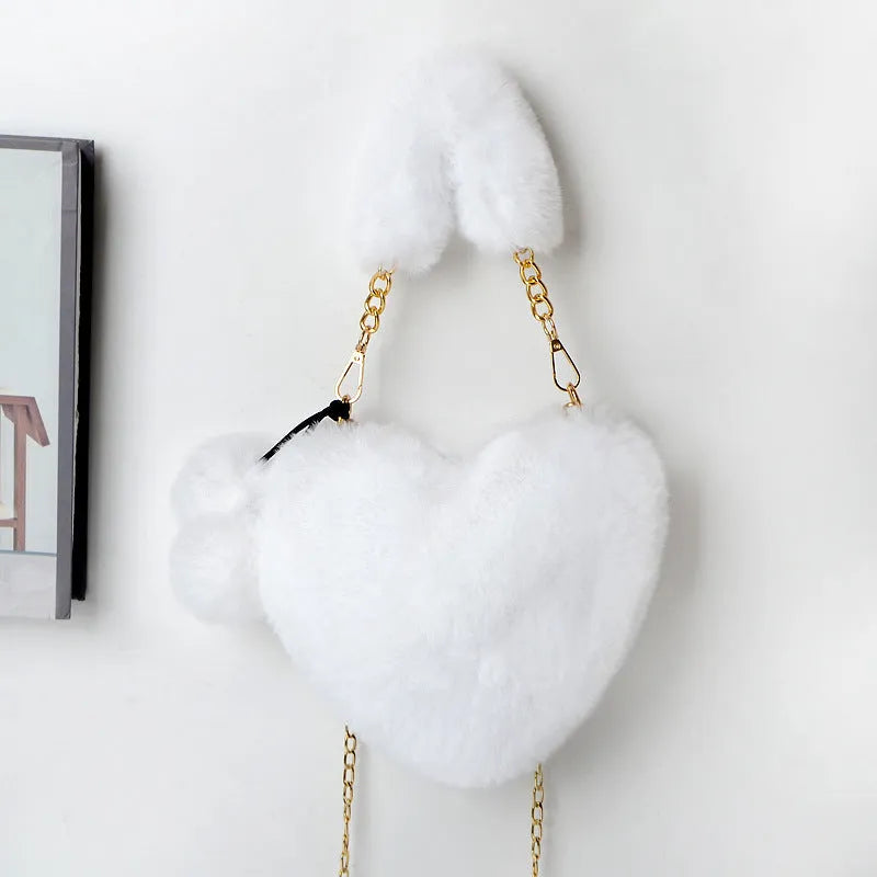 Love Bags soft plush heart-shaped handbag with zipper closure and removable handle in solid colour
