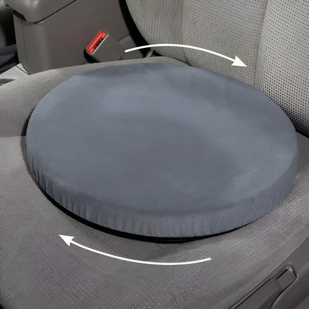 A grey rotating car seat cushion with a non-slip base, shown on a car seat.