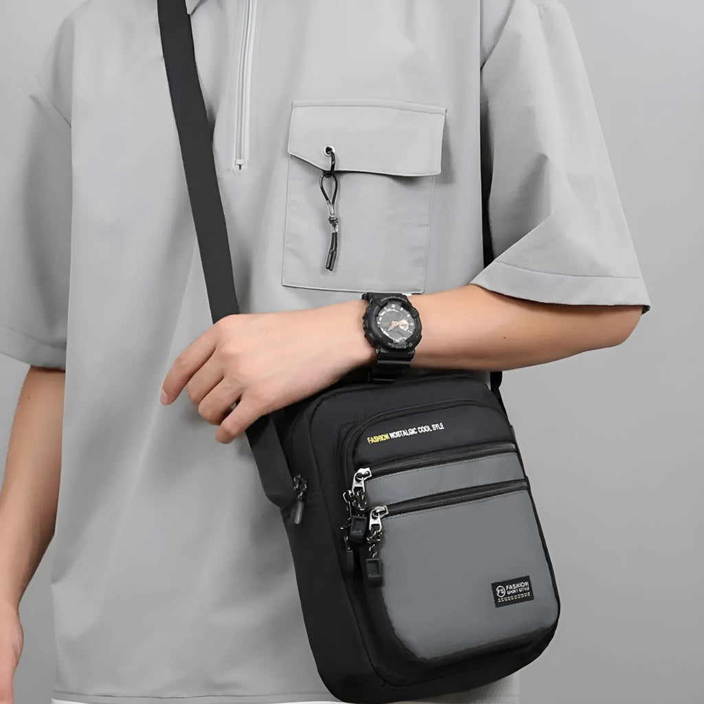 Men's nylon crossbody bag in solid colour with sewing thread detail, shown in green.