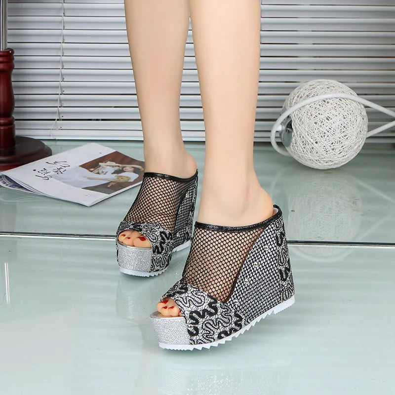 Women's black platform sandals with a hollowed-out chunky heel, mesh upper, and lace-up front.