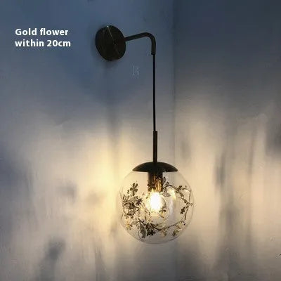Modern glass bedside wall lamp in golden flower or silver flower finish