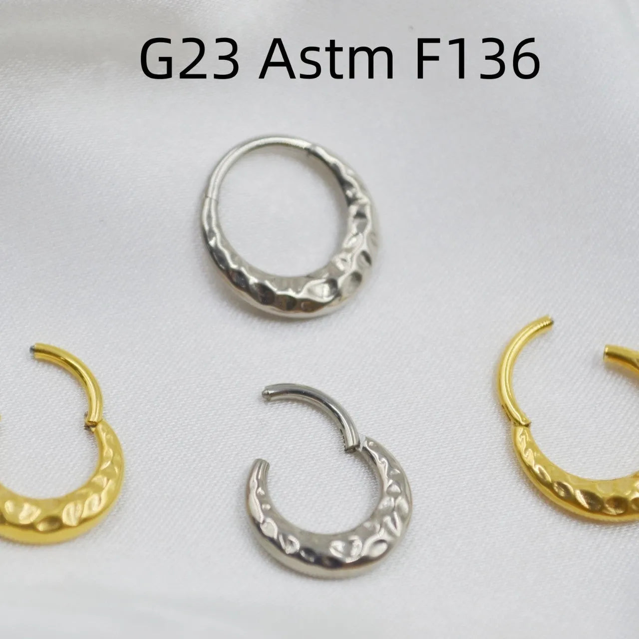 Close-up of a carved concave-convex titanium nose ring in silver finish