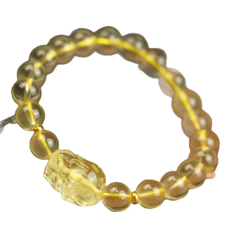 Yellow leather bracelet with artificial crystal beads and a Pi Xiu charm in simple Chinese style.