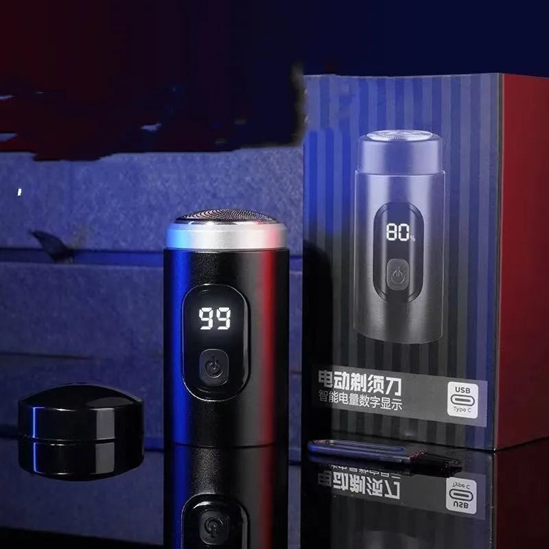 Black portable USB rechargeable shaver with cleaning brush and cable on a table.