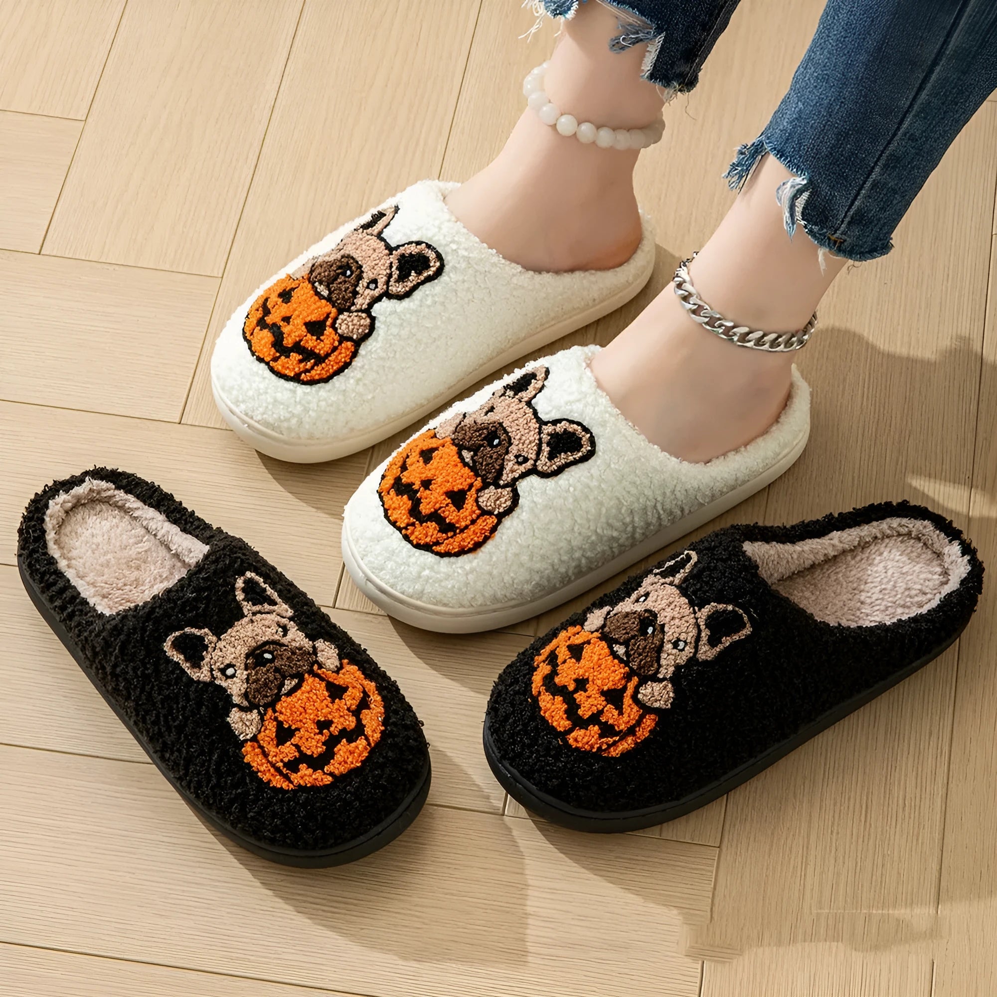 Black and white Halloween slippers with pumpkin design, plush upper, and textured TPR non-slip sole.
