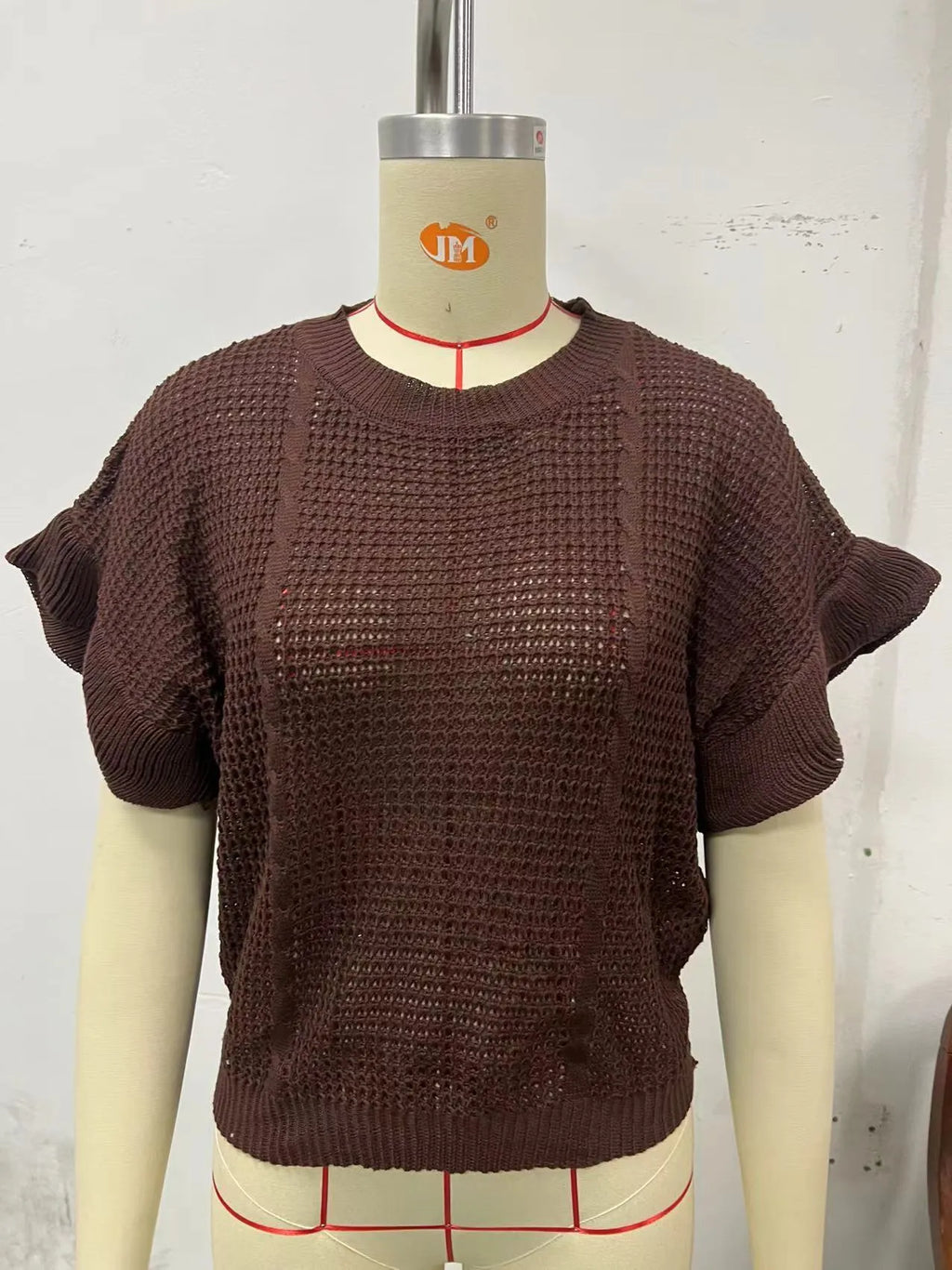 Women's loose fit knitted pullover with twisted string ruffled short sleeves in black colour