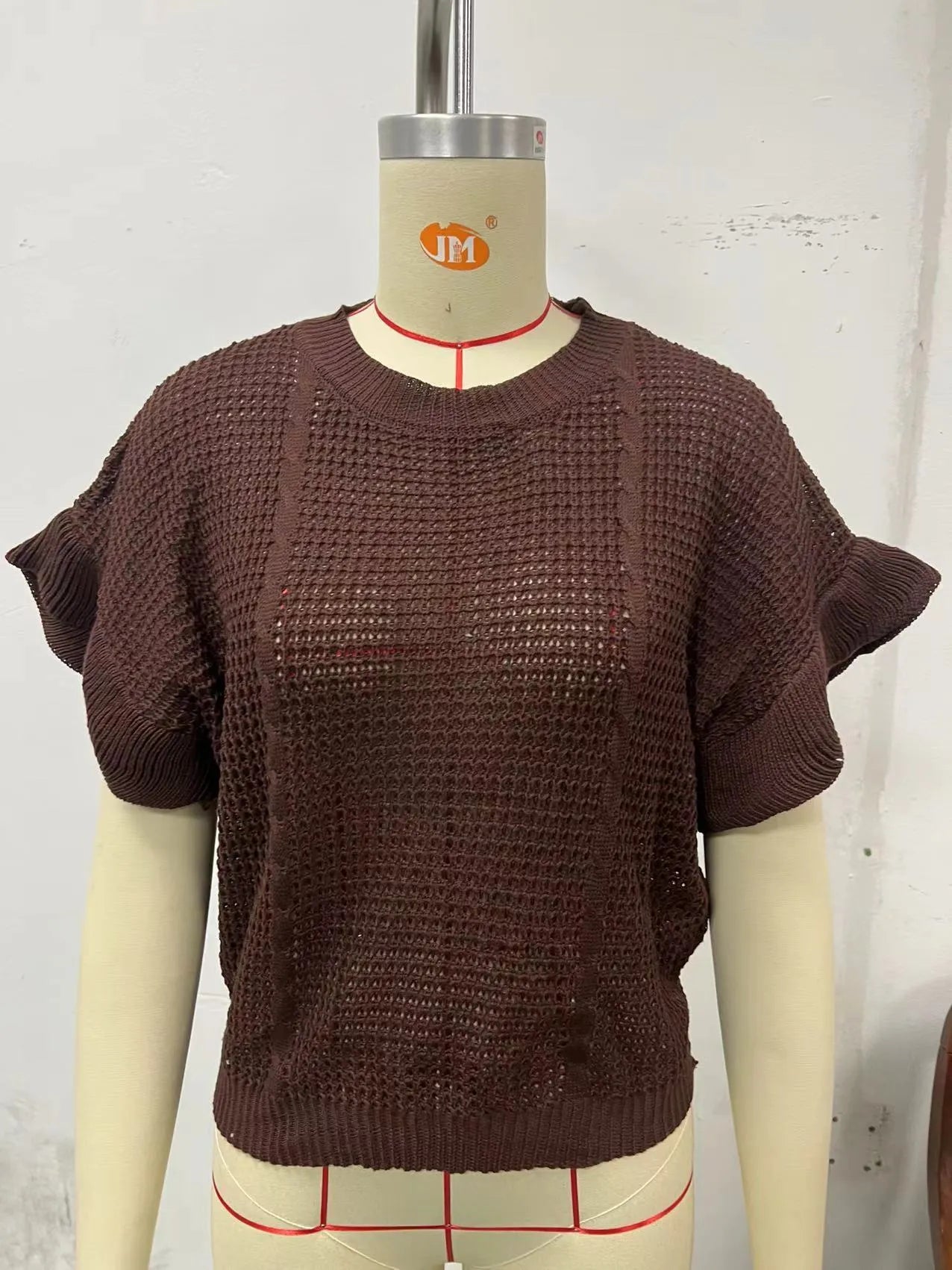 Women's loose fit knitted pullover with twisted string ruffled short sleeves in black colour