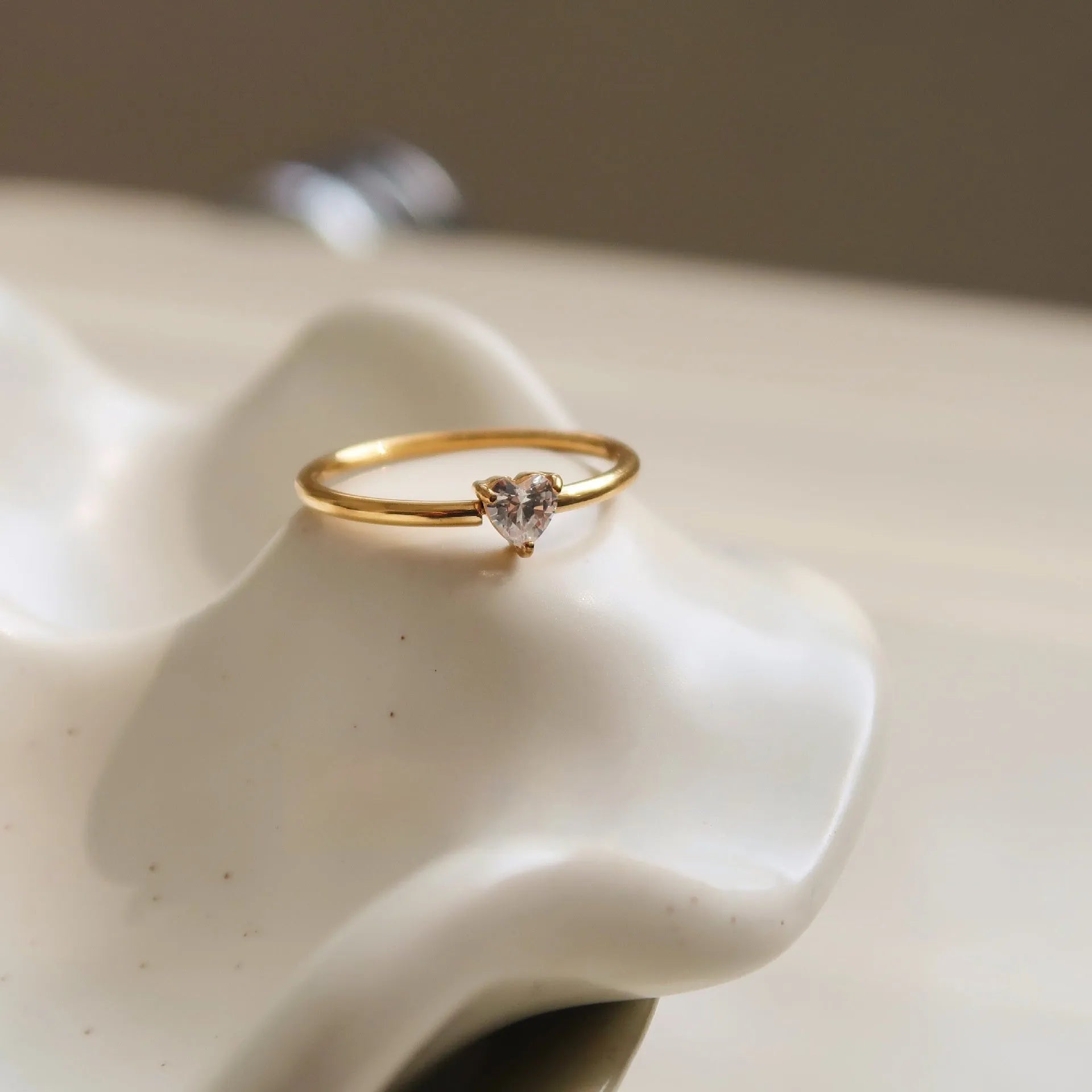 Golden love oval ring in stainless steel with electroplated finish showing heart design